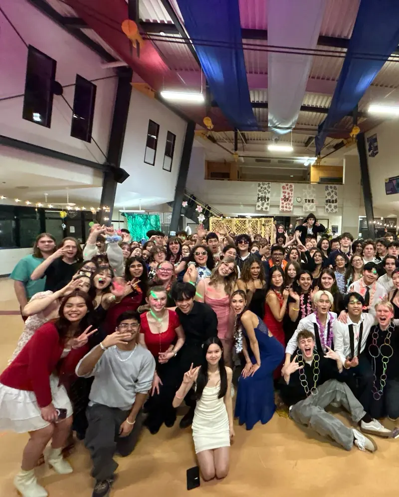 A large group of students posing together at a school dance